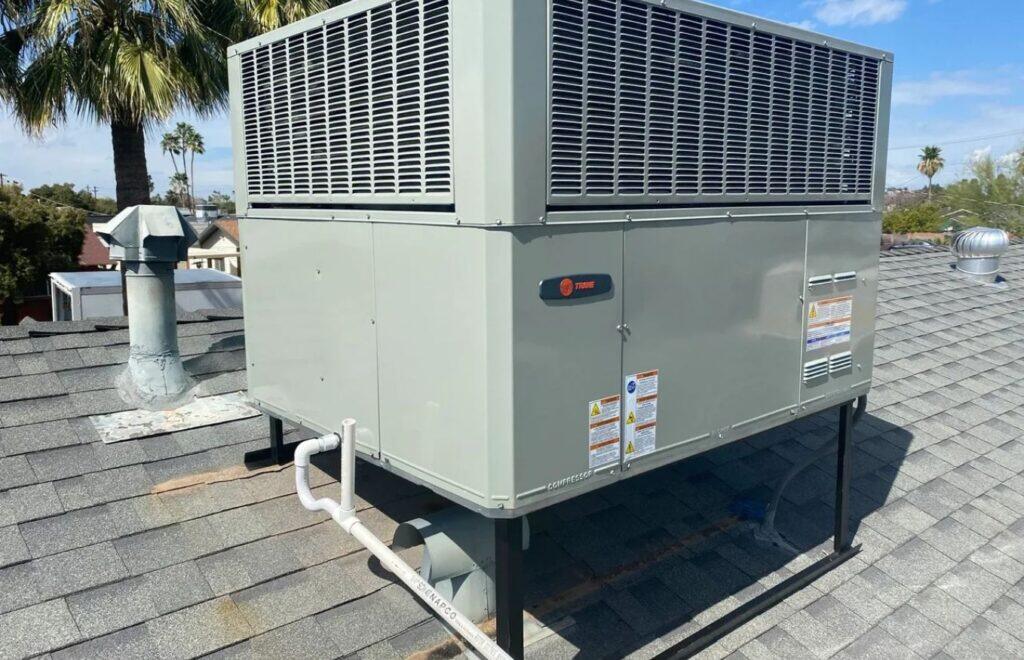 lacp-img-11 Commercial air conditioning unit on a roof, ensuring cooling efficiency for the building underneath.
